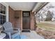 Cozy front porch detail featuring a chair and a welcome mat, adding to the home's charm at 6189 Primrose Ave, Indianapolis, IN 46220