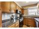 Kitchen features stainless steel appliances, neutral countertops, and traditional cabinetry at 6189 Primrose Ave, Indianapolis, IN 46220
