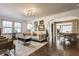 Open-concept living area with hardwood floors, a cozy sofa, and natural light at 6189 Primrose Ave, Indianapolis, IN 46220