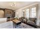 Bright living room features fireplace, hardwood floors, and abundant natural light from large windows at 6189 Primrose Ave, Indianapolis, IN 46220