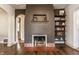 Charming living room features a fireplace with exposed brick and built-in shelving at 6189 Primrose Ave, Indianapolis, IN 46220