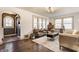 Spacious living room with an arched doorway and hardwood floors and stylish furniture at 6189 Primrose Ave, Indianapolis, IN 46220