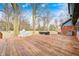 A spacious wooden deck with a grill, hot tub, and seating area, perfect for outdoor entertaining at 690 N 600 W, Lebanon, IN 46052
