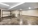 Spacious basement area featuring concrete floors, storage shelves, and a workout area at 690 N 600 W, Lebanon, IN 46052