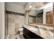 Well-lit bathroom features a large mirror and granite countertop at 690 N 600 W, Lebanon, IN 46052