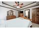 Bedroom featuring a tray ceiling, wood furniture and ensuite bathroom at 690 N 600 W, Lebanon, IN 46052