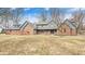 Charming brick home featuring blue wood accents, dormers, and a well-manicured lawn on a sunny day at 690 N 600 W, Lebanon, IN 46052