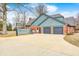 A spacious three-car garage featuring doors with a basketball hoop attached and a large driveway at 690 N 600 W, Lebanon, IN 46052