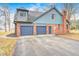 Attached three-car garage showcasing doors and driveway at 690 N 600 W, Lebanon, IN 46052