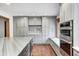 Kitchen featuring custom cabinets, stainless steel oven and microwave, decorative tile, and a cozy window seat at 690 N 600 W, Lebanon, IN 46052
