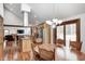 Open kitchen with stainless steel appliances, granite countertops, and a rustic dining table at 690 N 600 W, Lebanon, IN 46052