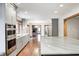 Open-concept kitchen with stainless steel oven and microwave, sleek counter tops, hardwood floors, and ample natural light at 690 N 600 W, Lebanon, IN 46052
