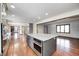 Open layout showing kitchen island with appliances and connection to additional living spaces with hardwood floors at 690 N 600 W, Lebanon, IN 46052
