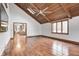Spacious room featuring a vaulted wood ceiling, large windows, and hardwood floors leading to kitchen at 690 N 600 W, Lebanon, IN 46052