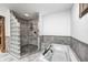Walk-in shower with stone tile and glass block partition at 690 N 600 W, Lebanon, IN 46052
