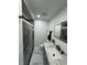 Updated bathroom features a glass shower, granite counters, and matte black hardware at 7406 E 33Rd St, Indianapolis, IN 46226