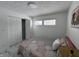 Bright bedroom featuring large closet doors and a cozy floral bedspread for added comfort at 7406 E 33Rd St, Indianapolis, IN 46226