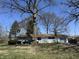 Charming single-story home with attached garage, mature trees, and a well-manicured lawn at 7406 E 33Rd St, Indianapolis, IN 46226