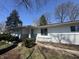 An inviting front entry with well-maintained landscaping and a freshly painted facade at 7406 E 33Rd St, Indianapolis, IN 46226