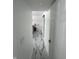 Hallway with marble-look flooring that flows into a bedroom with stylish accent and a sliding door at 7406 E 33Rd St, Indianapolis, IN 46226