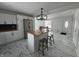 Open concept kitchen with island, new tile floor, stainless steel appliances and gray stools at 7406 E 33Rd St, Indianapolis, IN 46226