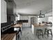 Kitchen with white cabinets, stainless appliances, dark backsplash and kitchen island with seating at 7406 E 33Rd St, Indianapolis, IN 46226