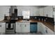 Modern kitchen with stainless appliances, wood countertops, and a black tile backsplash at 7406 E 33Rd St, Indianapolis, IN 46226