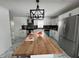 Kitchen with white cabinets, wood countertops, stainless steel refrigerator, and large island at 7406 E 33Rd St, Indianapolis, IN 46226