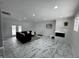 Spacious living room features marble floors, white brick fireplace, and ample natural light at 7406 E 33Rd St, Indianapolis, IN 46226