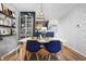 Cozy dining room featuring modern light fixture, seating for four, and adjacent kitchen at 7779 Harbour # 51, Indianapolis, IN 46240