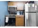Cozy kitchen featuring stainless steel appliances and wooden cabinets at 7779 Harbour # 51, Indianapolis, IN 46240