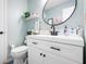 Chic powder room featuring a round mirror and modern fixtures at 7779 Harbour # 51, Indianapolis, IN 46240