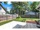 A backyard with a green lawn, a wood deck, and a wood fence surrounding the yard at 790 N 14Th St, Noblesville, IN 46060