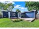 A backyard with a green lawn, a wood deck, and a blue house at 790 N 14Th St, Noblesville, IN 46060