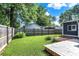 A backyard with a green lawn, a wood deck, and a wood fence surrounding the yard at 790 N 14Th St, Noblesville, IN 46060
