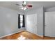 Bright bedroom featuring hardwood floors, a closet, and a ceiling fan at 790 N 14Th St, Noblesville, IN 46060