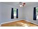 Bright bedroom featuring hardwood floors, two windows, and a ceiling fan at 790 N 14Th St, Noblesville, IN 46060