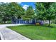 Charming navy blue home with manicured lawn, mature shade trees, and a detached garage with ample parking at 790 N 14Th St, Noblesville, IN 46060