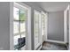 Hallway featuring three bright windows, a gray wall, and a dark floor at 790 N 14Th St, Noblesville, IN 46060