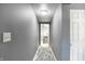 Hallway featuring tile floors and leads to the stylishly decorated bathroom at 790 N 14Th St, Noblesville, IN 46060