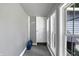 Hallway with natural light, a white door, a gray wall, and a gray floor at 790 N 14Th St, Noblesville, IN 46060
