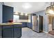 Charming kitchen featuring updated cabinets, flooring, lighting, and stainless steel refrigerator at 790 N 14Th St, Noblesville, IN 46060