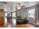 Spacious living room with hardwood floors, ceiling fan, and ample natural light from large windows at 790 N 14Th St, Noblesville, IN 46060