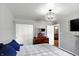 Bright main bedroom featuring a large closet, chandelier, and dark wood dresser at 790 N 14Th St, Noblesville, IN 46060