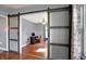 Open floorplan showcases the glass panel barn door and the living room at 790 N 14Th St, Noblesville, IN 46060