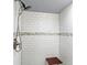 Clean walk-in shower with subway tile, built-in seat, and modern shower head at 790 N 14Th St, Noblesville, IN 46060