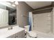 Neutral bathroom featuring a vanity with sink and a shower-tub combination with blue shower curtain at 8394 S Shady Trail Dr, Pendleton, IN 46064