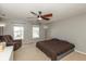 A neutral bedroom with a ceiling fan, two windows and minimalist decor at 8394 S Shady Trail Dr, Pendleton, IN 46064