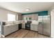 Modern kitchen with stainless steel appliances, gray cabinetry, and granite countertops, perfect for cooking at 8394 S Shady Trail Dr, Pendleton, IN 46064