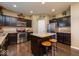 Well-equipped kitchen with dark cabinets, stainless steel appliances, a granite island with seating, and recessed lighting at 8416 Whitaker Valley Blvd, Indianapolis, IN 46237